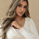 Woman with styled hair against a beige background